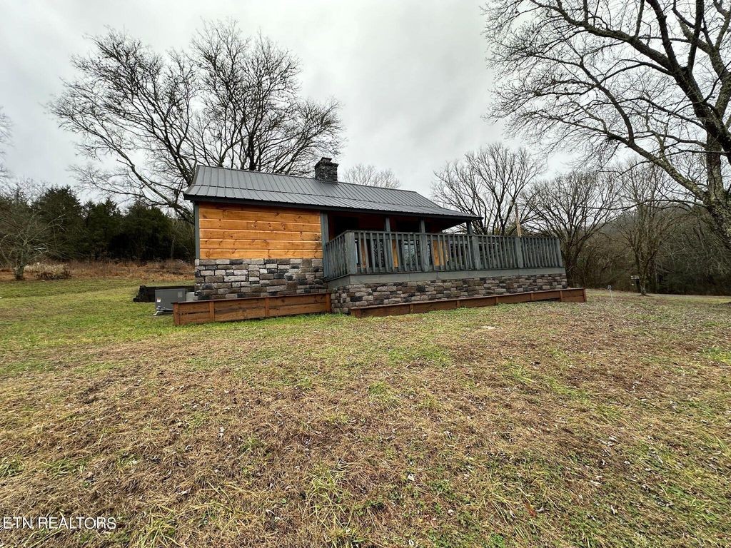 363 Enigma Road Chestnut Mound, TN 38552 - Photo 25 of 60 a front view of a house with a yard