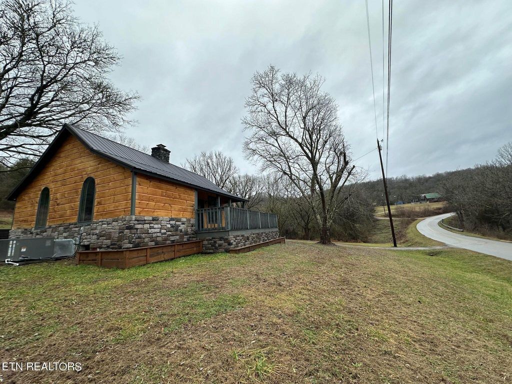 363 Enigma Road Chestnut Mound, TN 38552 - Photo 29 of 60 a front view of a house with a yard