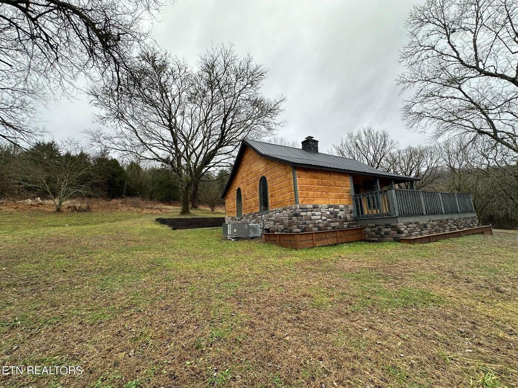 363 Enigma Road Chestnut Mound, TN 38552 - Photo 34 of 60 a front view of a house with garden