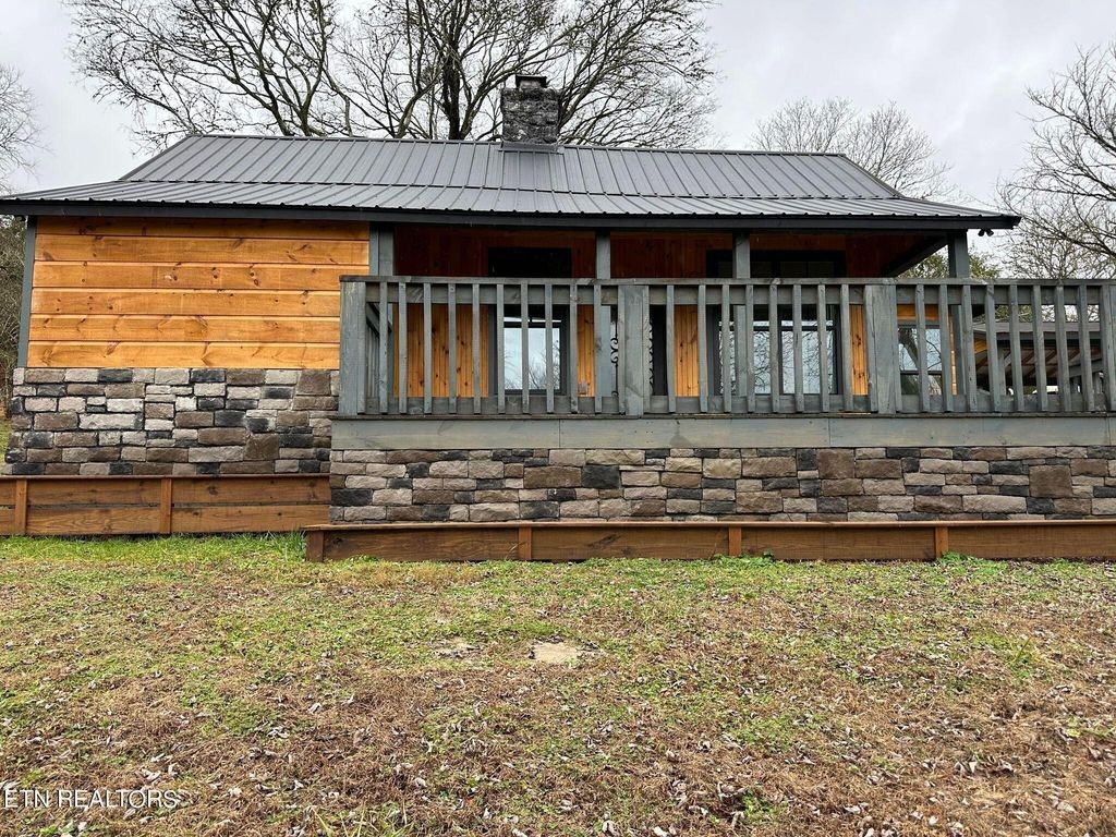363 Enigma Road Chestnut Mound, TN 38552 - Photo 35 of 60 a front view of a house with swimming pool and porch with furniture