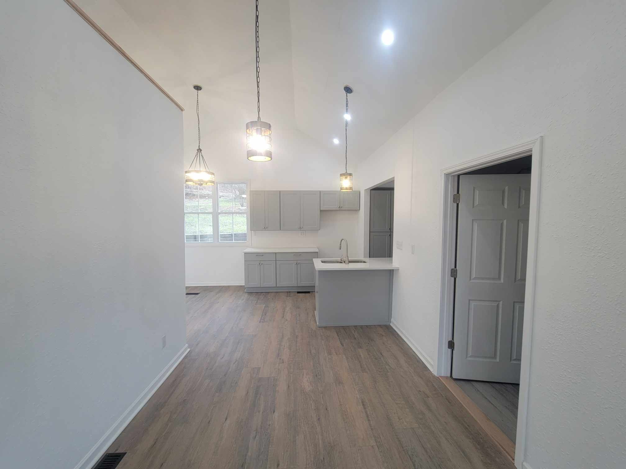 363 Enigma Road Chestnut Mound, TN 38552 - Photo 9 of 60 a large kitchen with a lot of cabinets and wooden floor