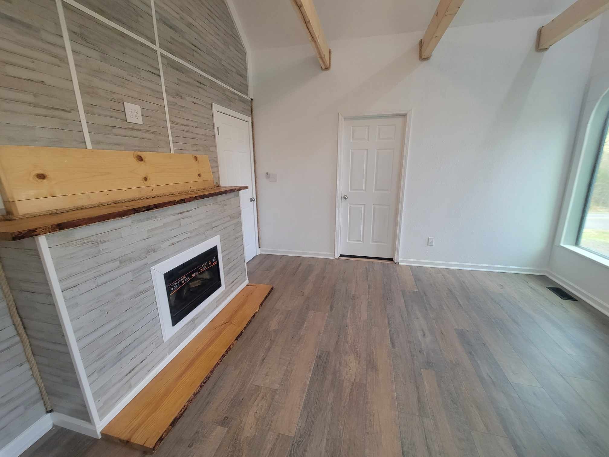 363 Enigma Road Chestnut Mound, TN 38552 - Photo 10 of 60 a view of a livingroom with wooden floor and a fireplace
