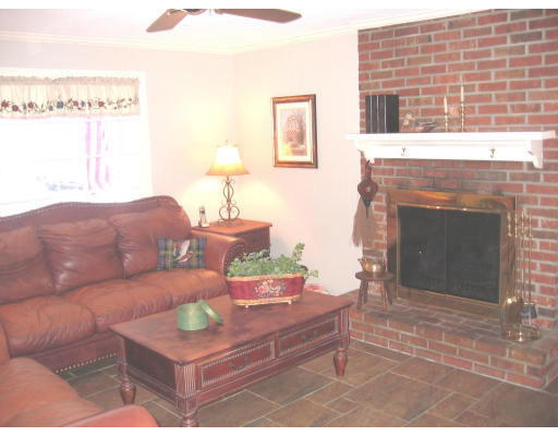 9 Russell Road Wilbraham, MA 01095 - Photo 11 of 12 a living room with furniture a window and a fireplace