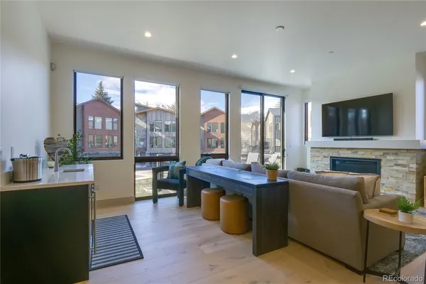 a living room with fireplace furniture and a flat screen tv