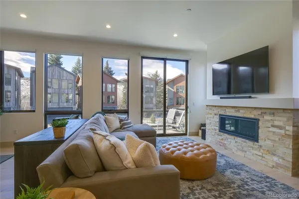 a living room with furniture fireplace and flat screen tv