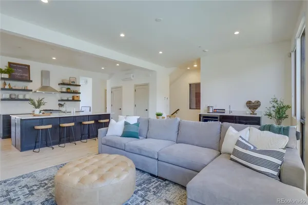 a living room with furniture and kitchen view