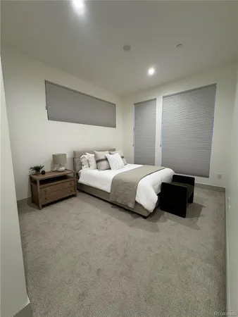 a bedroom with a bed and a couch