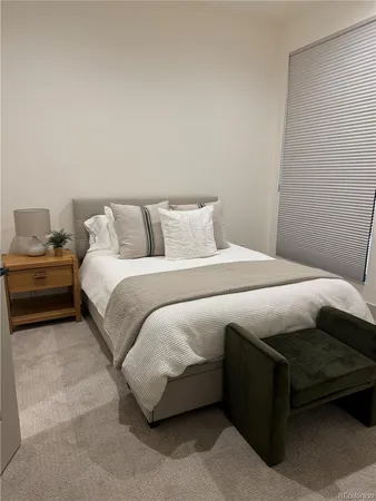 a bedroom with a bed and flat screen tv