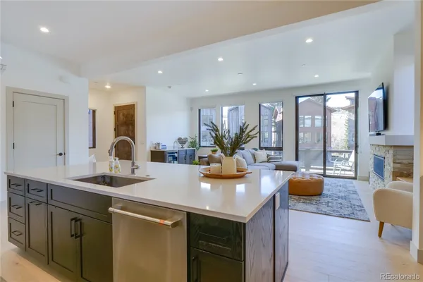 a view of kitchen island a sink and living room