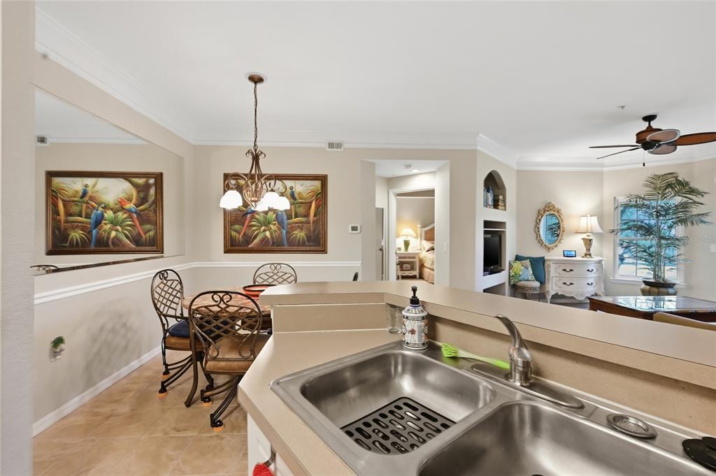 5122 Northridge Road, Unit 210 Sarasota, FL 34238 - Photo 11 of 36 a living room with furniture and a chandelier