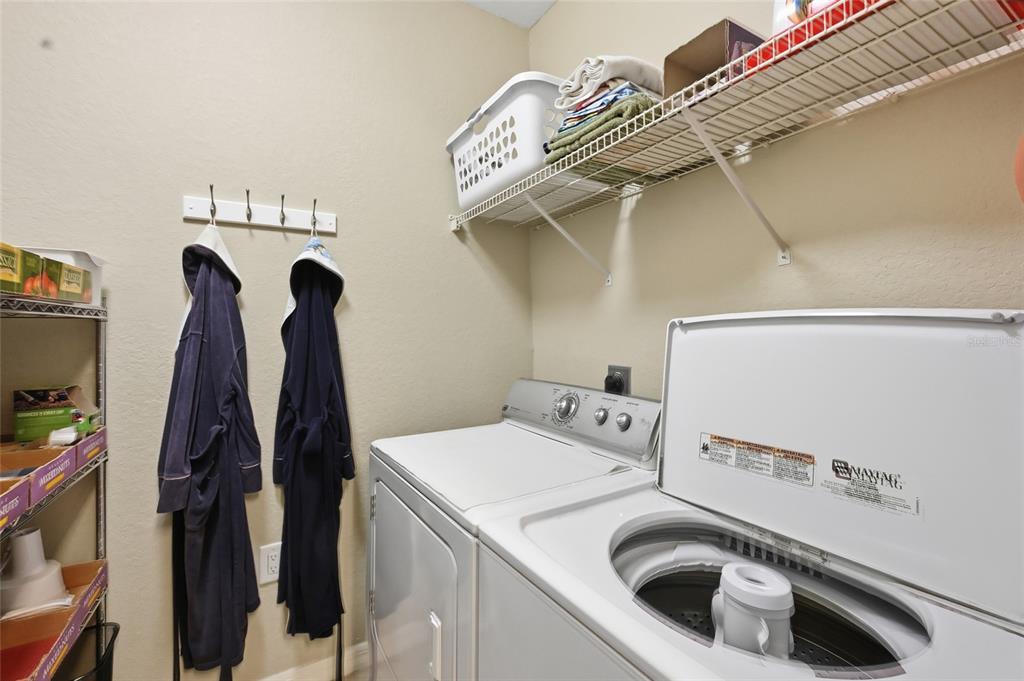 5122 Northridge Road, Unit 210 Sarasota, FL 34238 - Photo 13 of 36 a utility room with dryer and washer