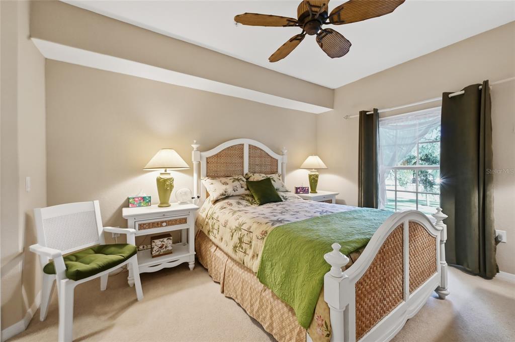 5122 Northridge Road, Unit 210 Sarasota, FL 34238 - Photo 14 of 36 a bedroom with a bed gym equipment and a large window