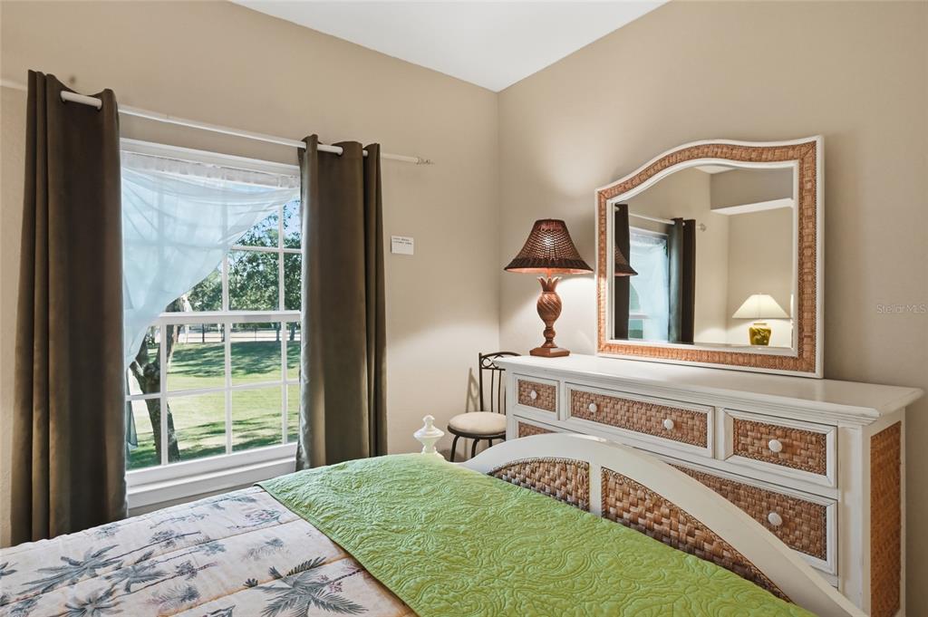 5122 Northridge Road, Unit 210 Sarasota, FL 34238 - Photo 15 of 36 a living room with a bed furniture and a large window