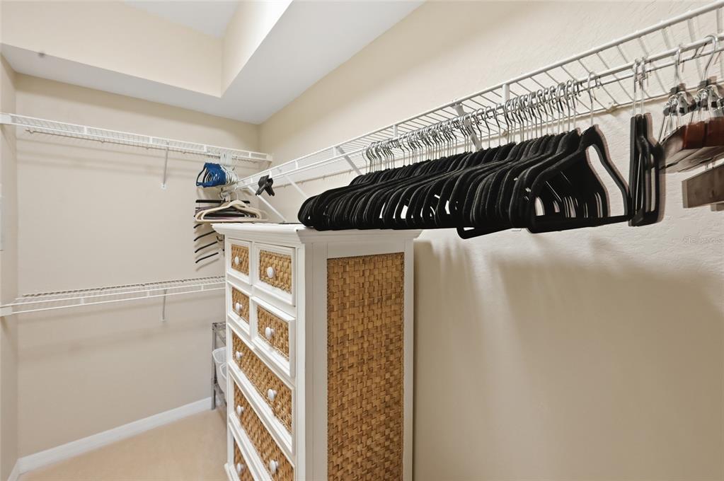 5122 Northridge Road, Unit 210 Sarasota, FL 34238 - Photo 16 of 36 a view of walk in closet with clothes and shoes