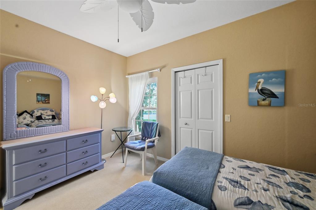 5122 Northridge Road, Unit 210 Sarasota, FL 34238 - Photo 19 of 36 a bedroom with a bed and a dresser in it