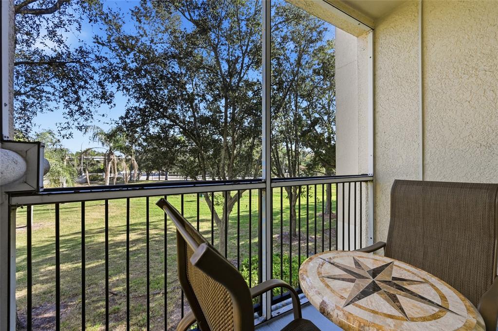 5122 Northridge Road, Unit 210 Sarasota, FL 34238 - Photo 24 of 36 a balcony with wooden floor