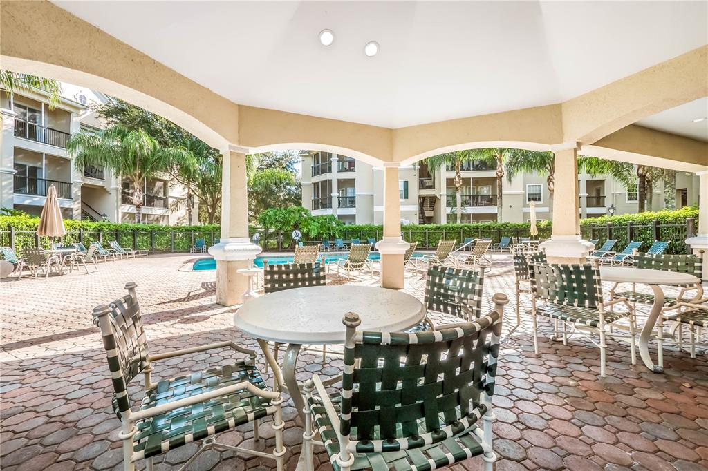 5122 Northridge Road, Unit 210 Sarasota, FL 34238 - Photo 33 of 36 a view of a patio with couches table and chairs