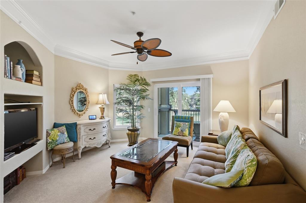 5122 Northridge Road, Unit 210 Sarasota, FL 34238 - Photo 5 of 36 a living room with furniture a flat screen tv and a window