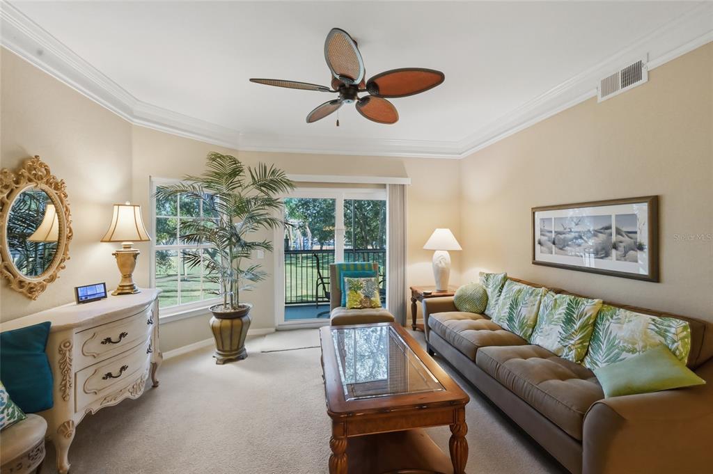 5122 Northridge Road, Unit 210 Sarasota, FL 34238 - Photo 6 of 36 a living room with furniture and a large window