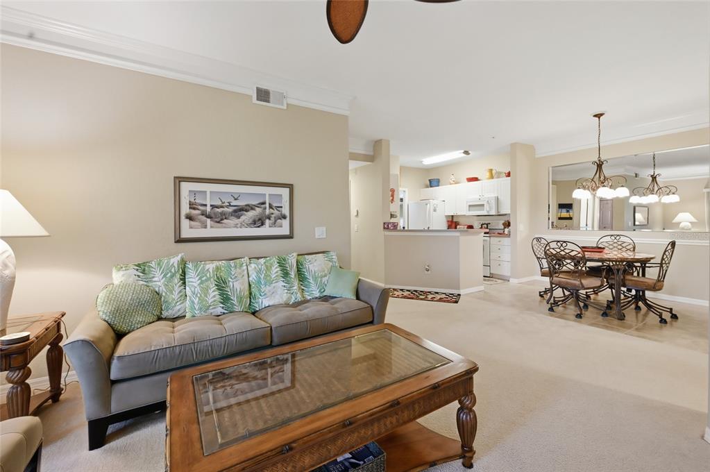 5122 Northridge Road, Unit 210 Sarasota, FL 34238 - Photo 7 of 36 a living room with furniture and kitchen view