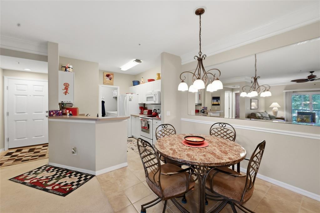 5122 Northridge Road, Unit 210 Sarasota, FL 34238 - Photo 8 of 36 a view of a dining room and chandelier