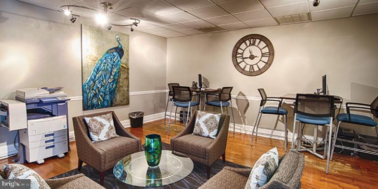 3900 Chestnut Street, Unit 203 Philadelphia, PA 19104 - Photo 2 of 13 a view of a dining room with furniture a rug and a chandelier