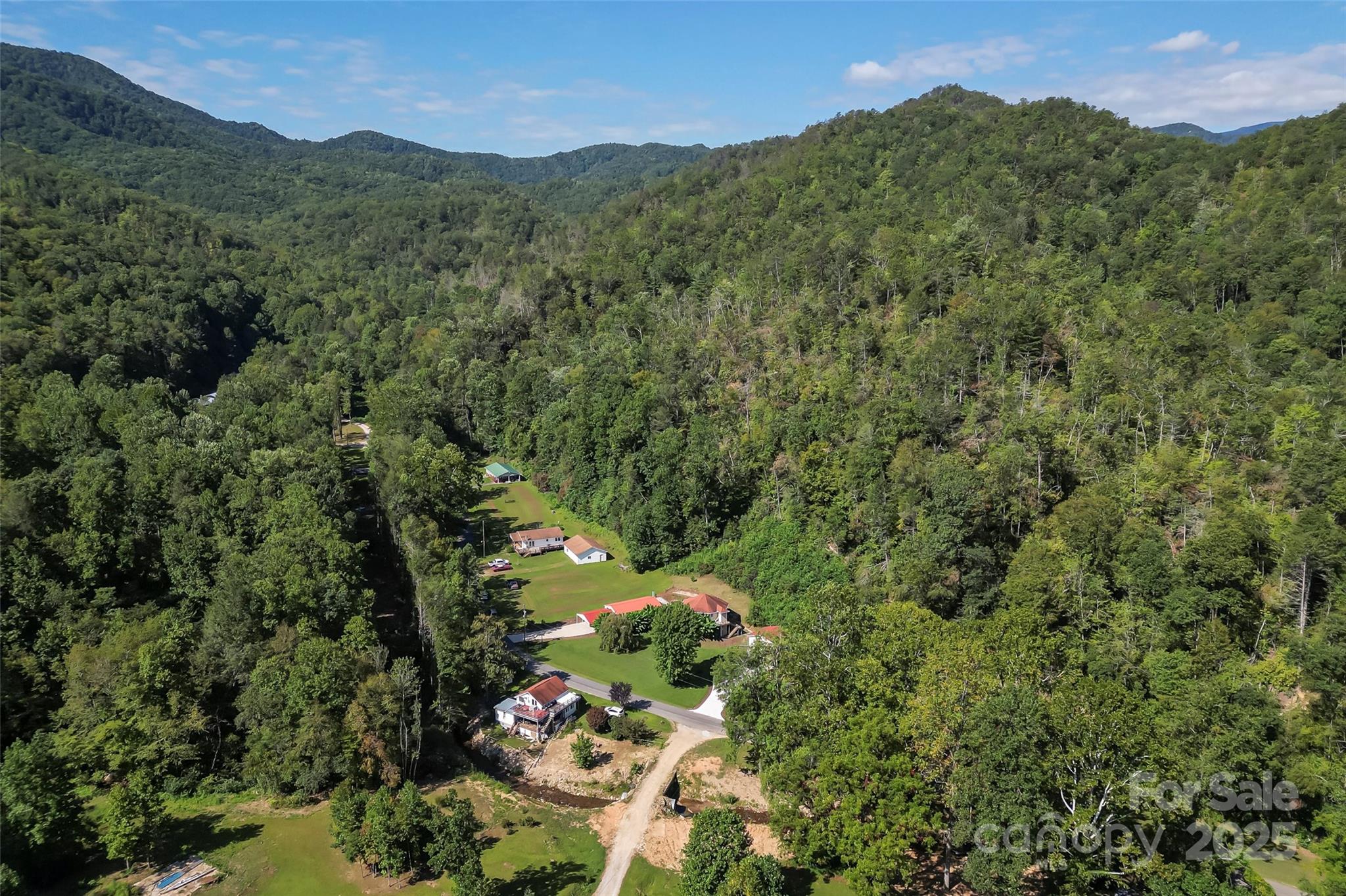 214 Locust Cove Road Marion, NC 28752 - Photo 11 of 47 a view of a lush green hillside and houses
