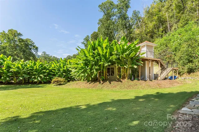 a dining room with furniture a chandelier and wooden floor