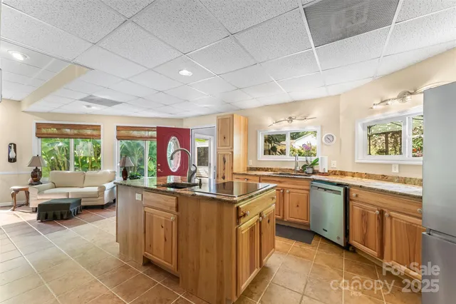 a bedroom with a bed lamp and a large window