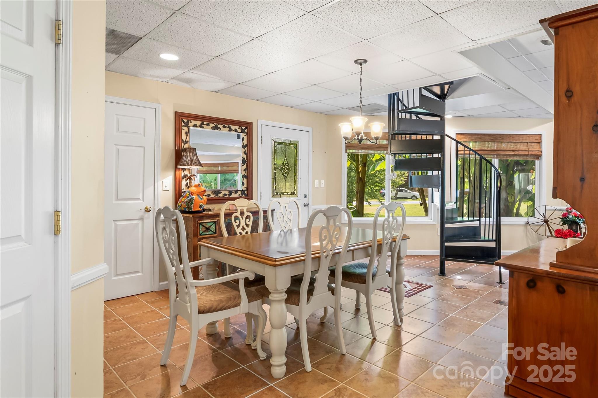214 Locust Cove Road Marion, NC 28752 - Photo 24 of 47 a dining room with furniture a chandelier and wooden floor