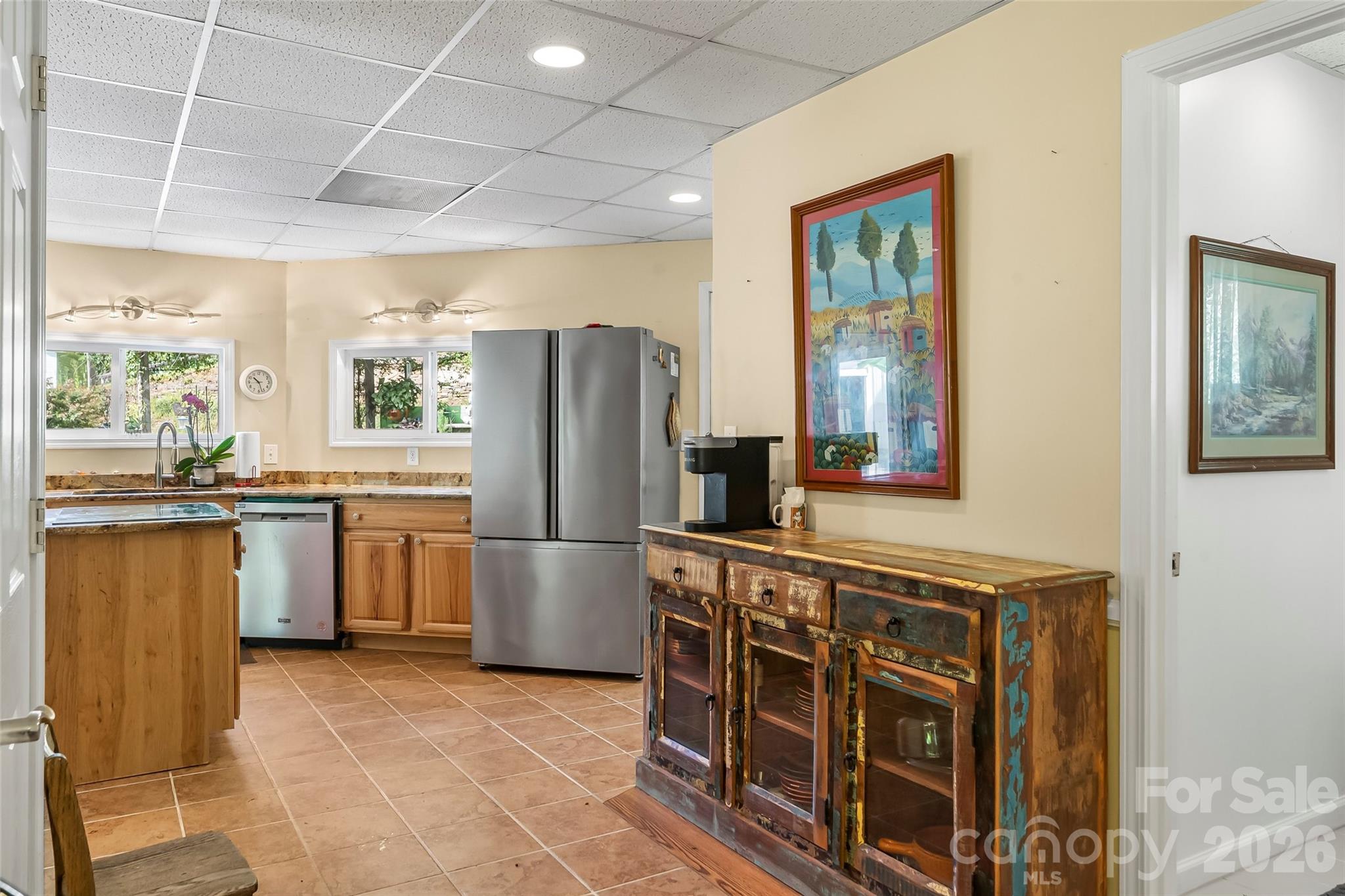 214 Locust Cove Road Marion, NC 28752 - Photo 25 of 47 a kitchen with refrigerator cabinets and large window