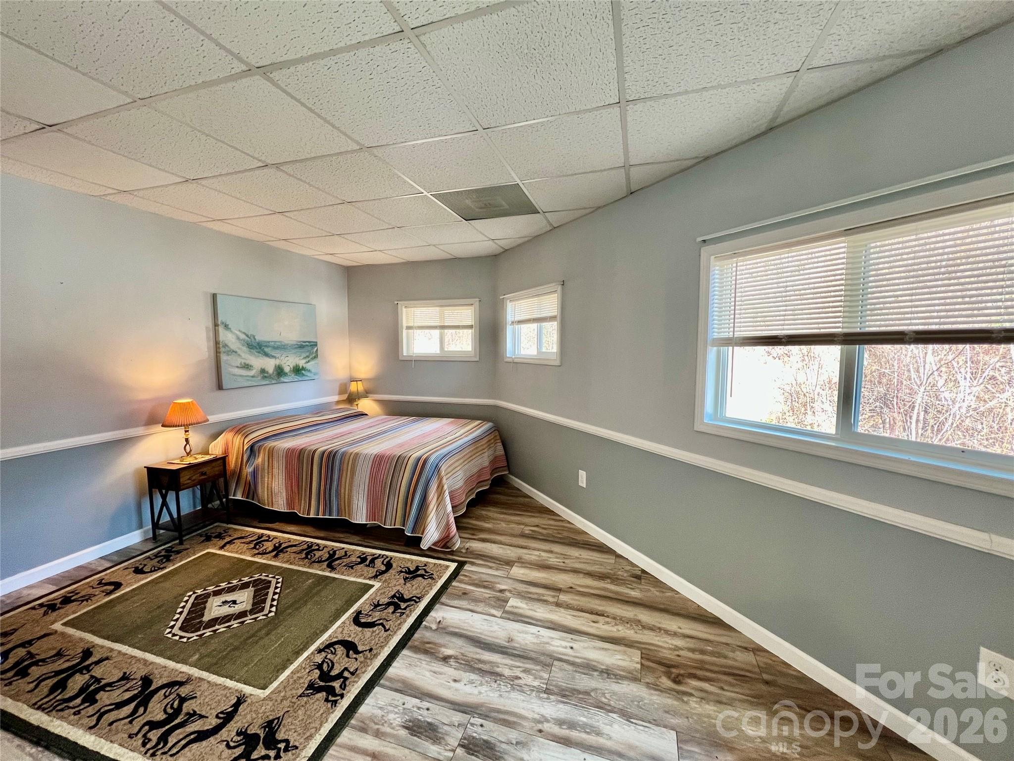 214 Locust Cove Road Marion, NC 28752 - Photo 28 of 47 a bedroom with a bed and wooden floor