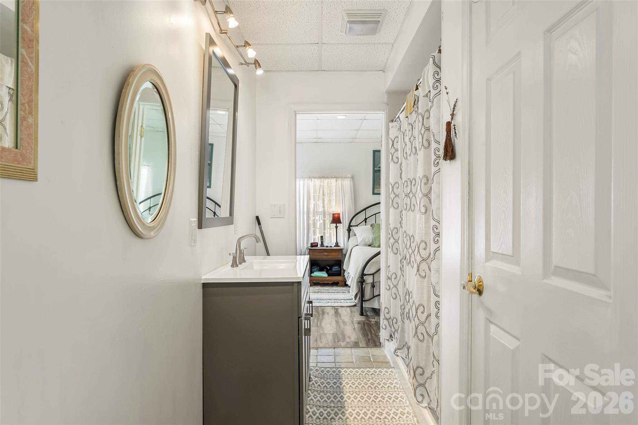 214 Locust Cove Road Marion, NC 28752 - Photo 29 of 47 a bathroom with a sink a mirror and a shower curtain