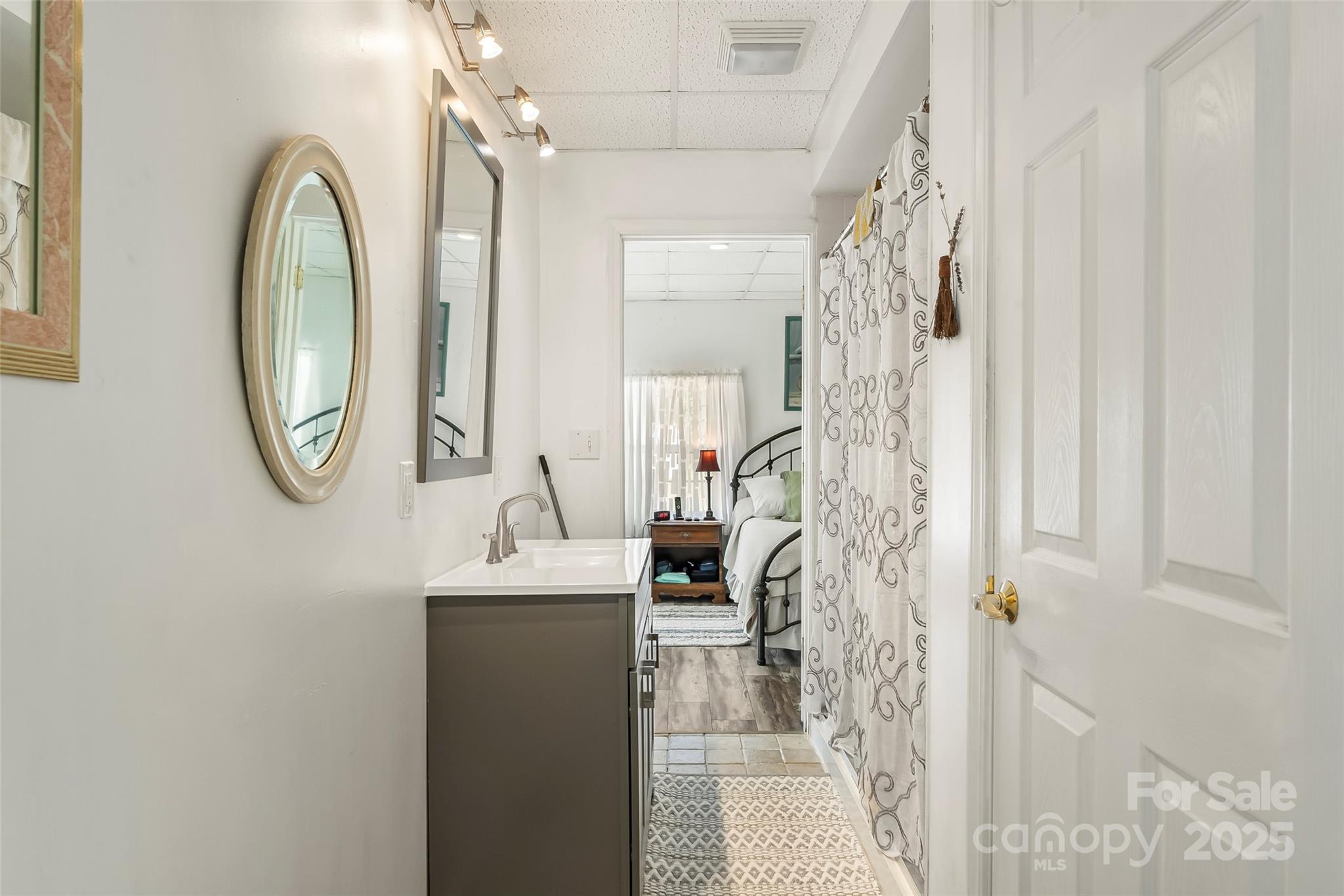 214 Locust Cove Road Marion, NC 28752 - Photo 30 of 47 a bathroom with a sink a mirror and a shower curtain