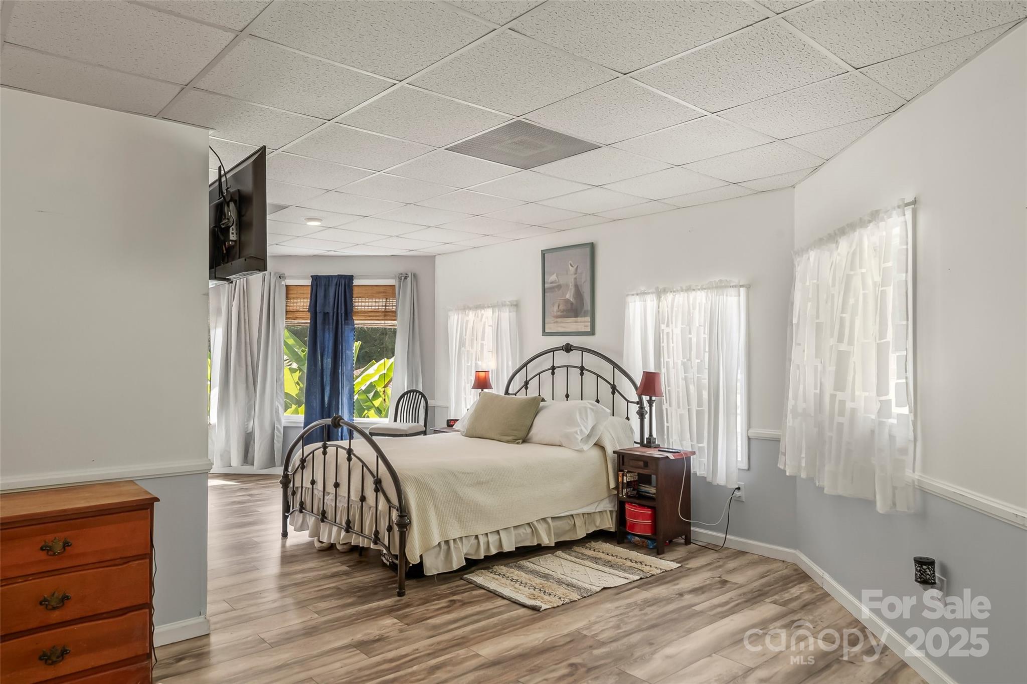 214 Locust Cove Road Marion, NC 28752 - Photo 32 of 47 a bedroom with a bed lamp and a large window