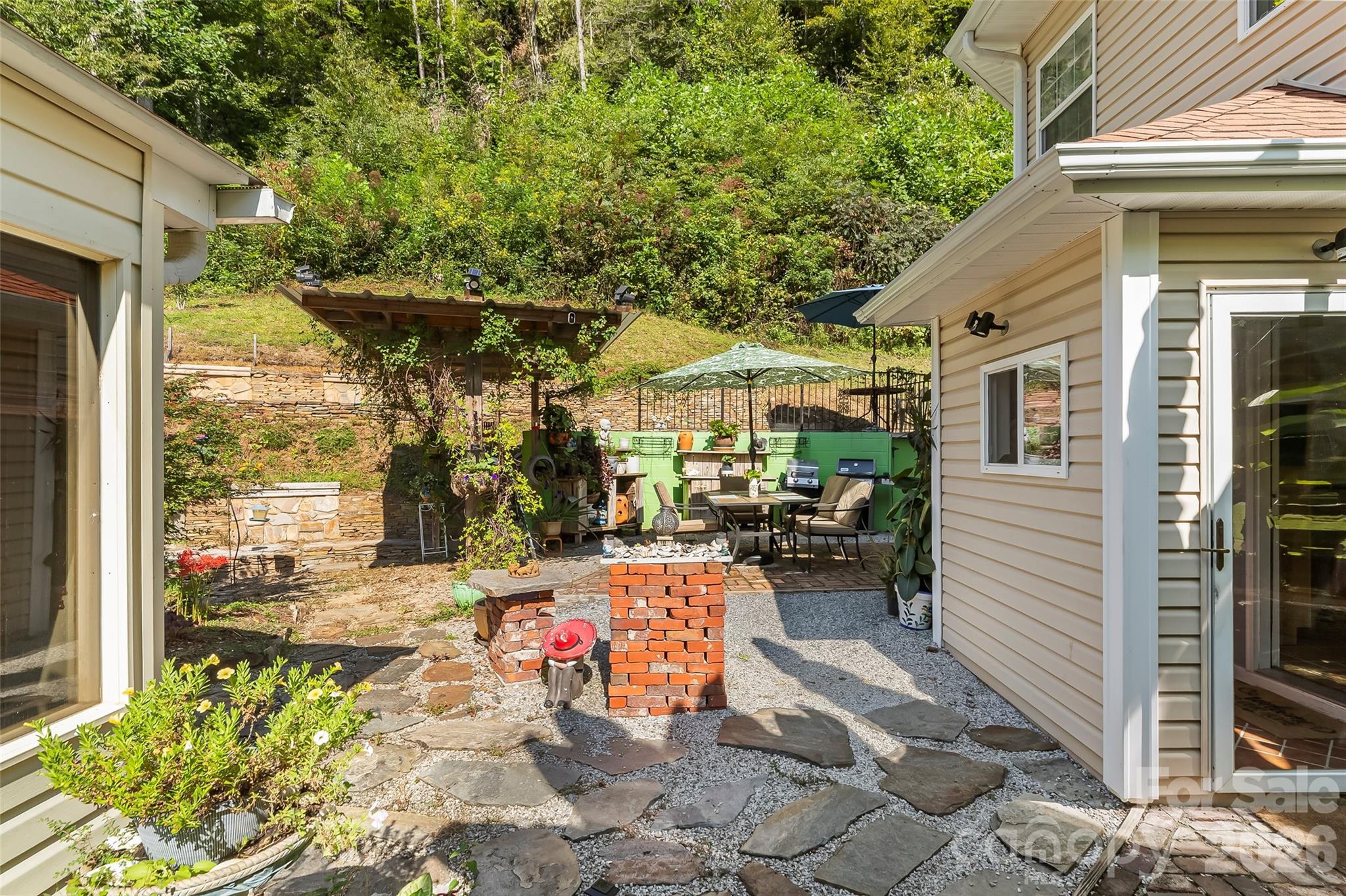 214 Locust Cove Road Marion, NC 28752 - Photo 33 of 47 a view of a patio with table and chairs and potted plants