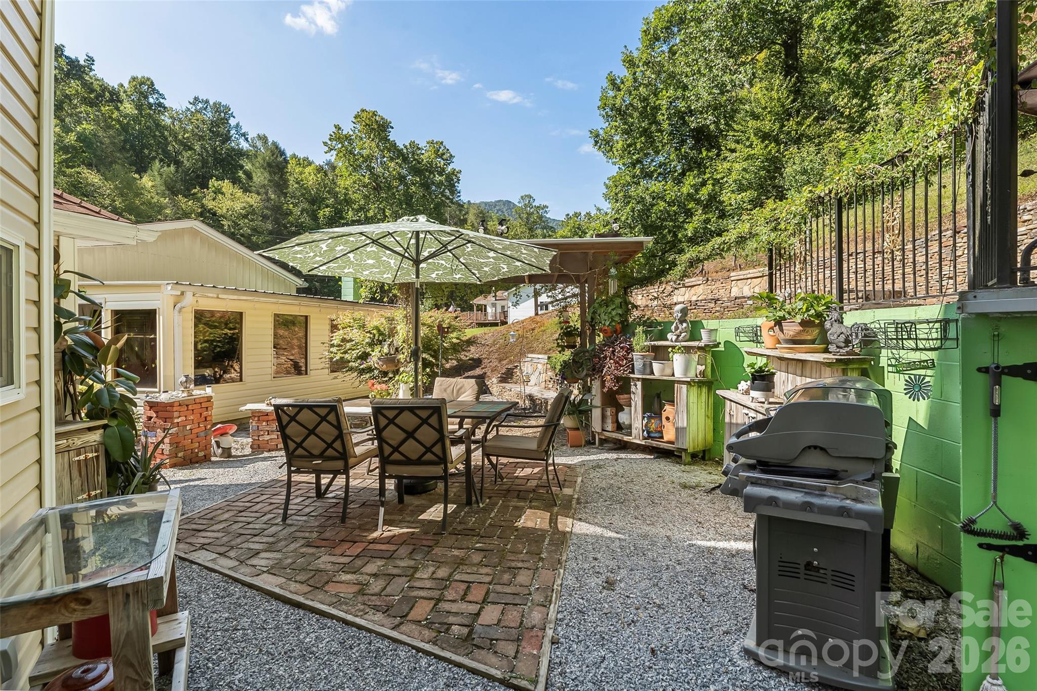 214 Locust Cove Road Marion, NC 28752 - Photo 35 of 47 a view of a house with backyard sitting area and garden