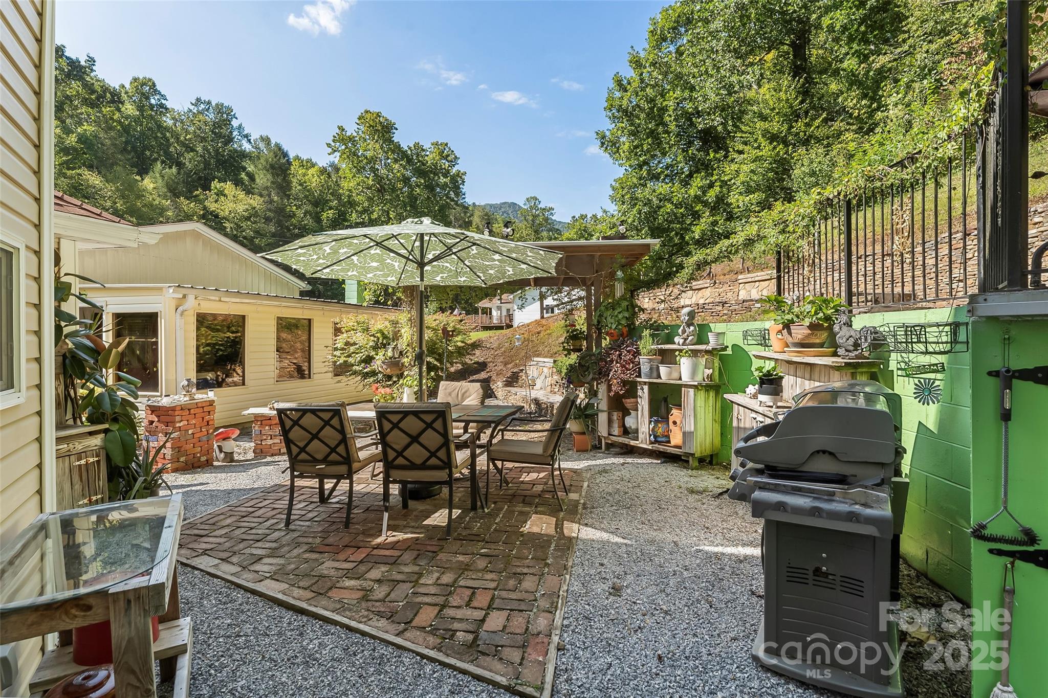 214 Locust Cove Road Marion, NC 28752 - Photo 36 of 47 a view of a house with backyard sitting area and garden