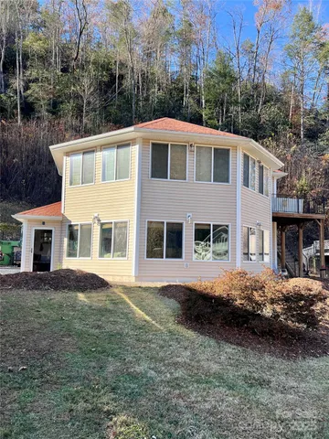 a view of a lush green hillside and houses