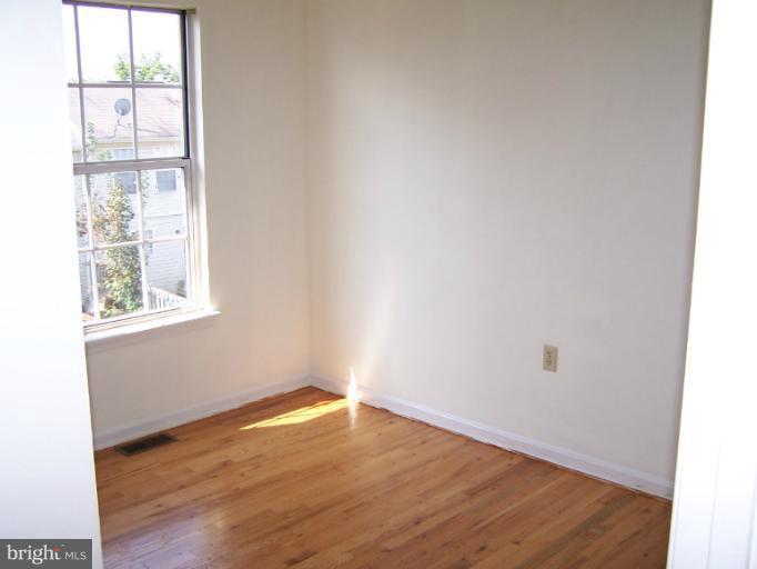 348 Valley Mill Road Winchester, VA 22602 - Photo 2 of 11 an empty room with wooden floor and windows
