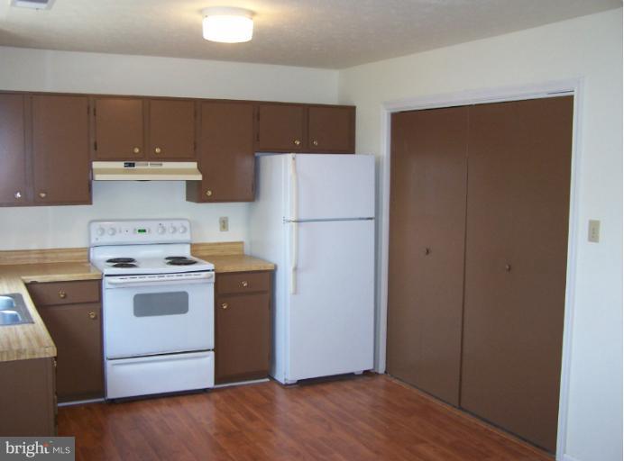 348 Valley Mill Road Winchester, VA 22602 - Photo 5 of 11 a kitchen with a white stove top oven and refrigerator