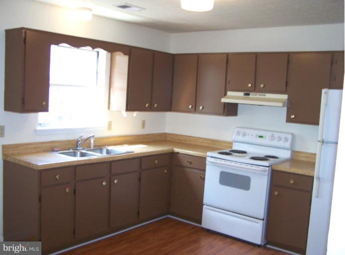 348 Valley Mill Road Winchester, VA 22602 - Photo 7 of 11 a kitchen with a stove sink and cabinets