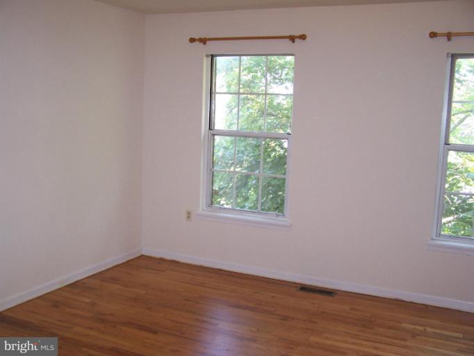 348 Valley Mill Road Winchester, VA 22602 - Photo 8 of 11 a view of an empty room with wooden floor and a window