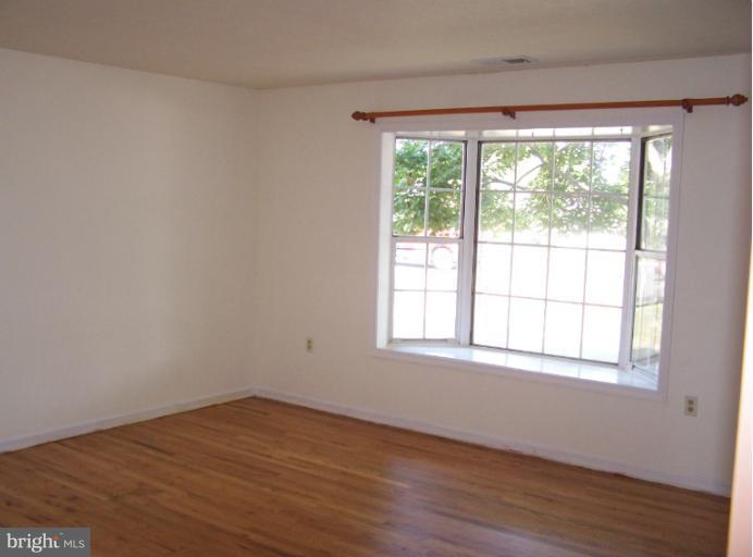 348 Valley Mill Road Winchester, VA 22602 - Photo 9 of 11 a view of an empty room with wooden floor and a window