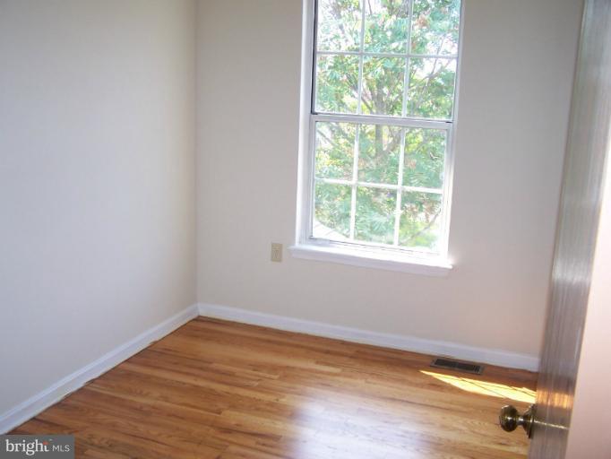 348 Valley Mill Road Winchester, VA 22602 - Photo 10 of 11 an empty room with wooden floor and windows