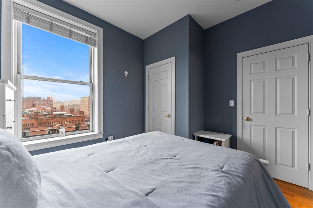 483 Beacon Street, Unit 63 Boston, MA 02115 - Photo 4 of 10 a bedroom with a bed and a large window