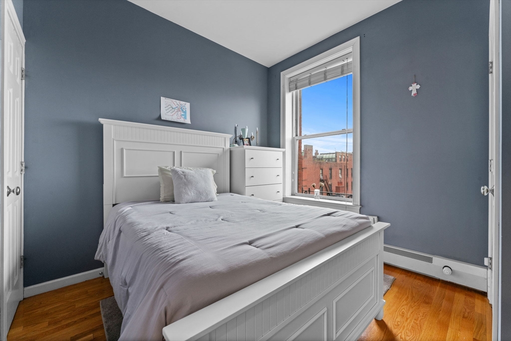 483 Beacon Street, Unit 63 Boston, MA 02115 - Photo 5 of 10 a bedroom with a bed and a window