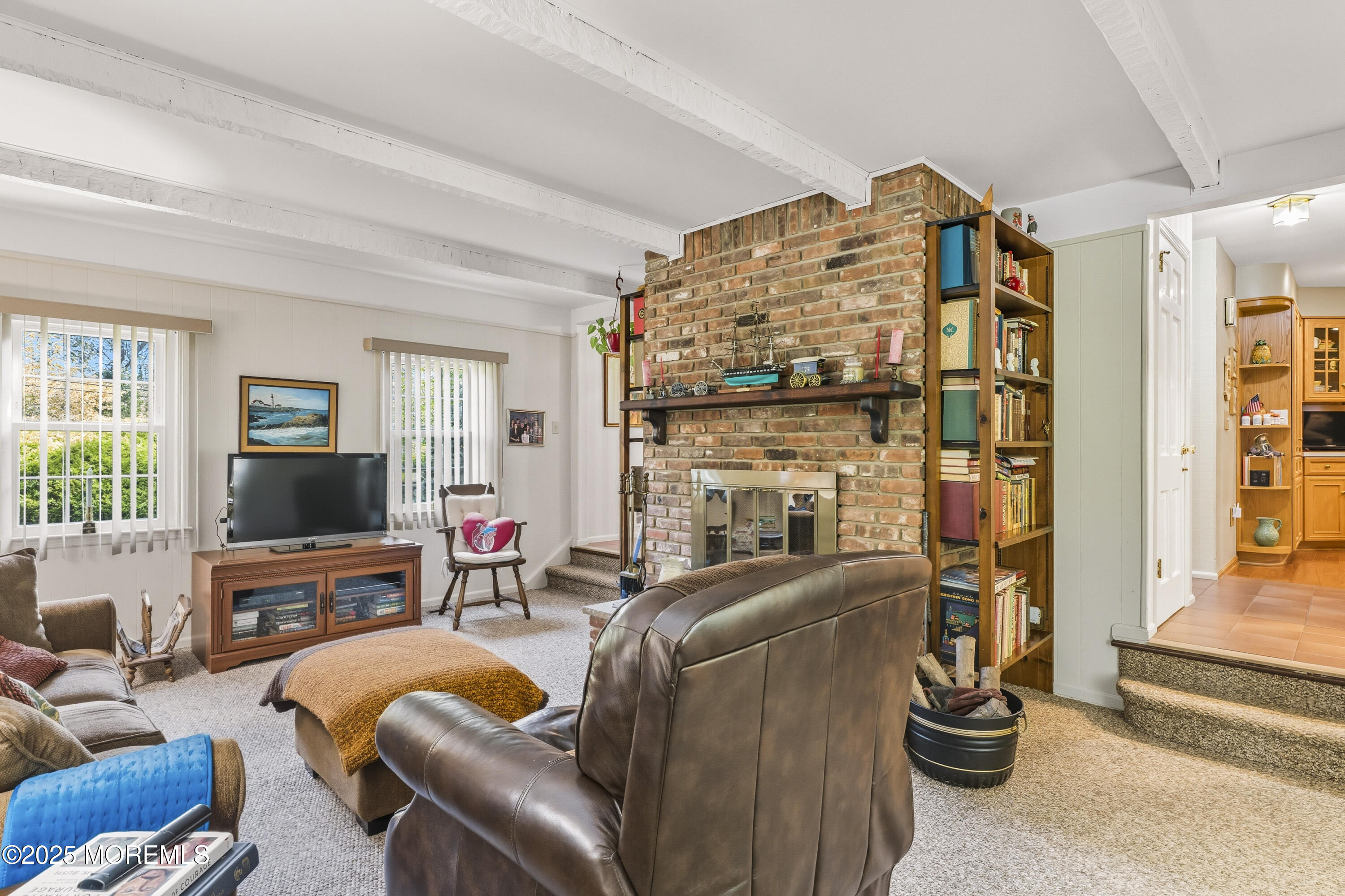 9 Mulberry Lane Colts Neck, NJ 07722 - Photo 15 of 36 a living room with furniture a fireplace and a flat screen tv