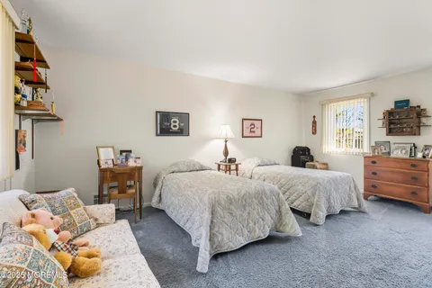 a bed room with two bed and a window