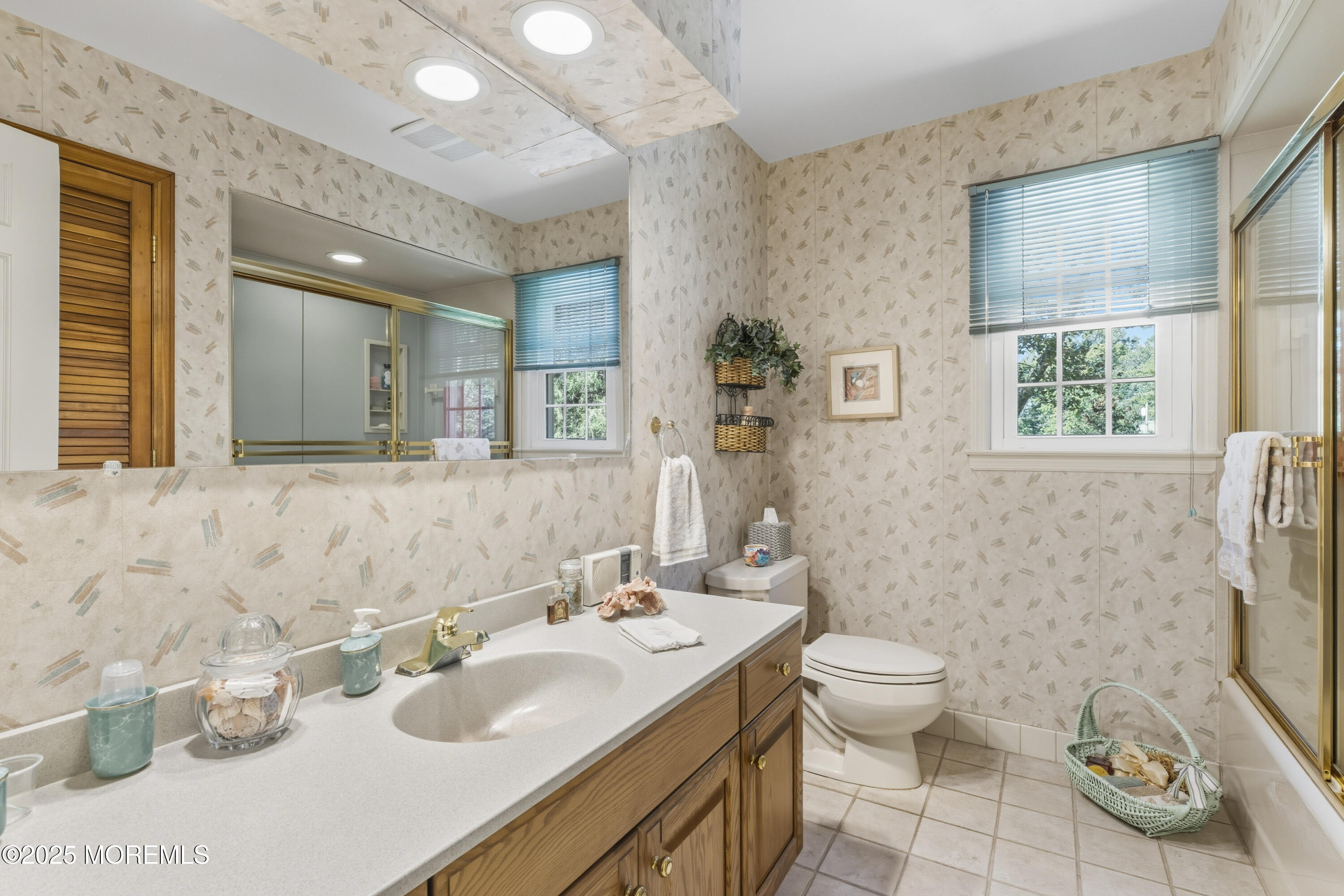 9 Mulberry Lane Colts Neck, NJ 07722 - Photo 22 of 36 a bathroom with a granite countertop toilet a sink and a large mirror